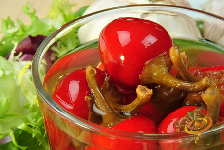 Red cherry hot pepper seeds from SeedsNow, showing small vibrant red peppers and seed packets for spicy culinary use.